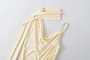 Close-up detail of light yellow halter neck camisole with draped cowl neck design