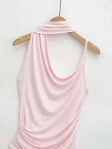 Macro detail of a soft pink halter neck sleeveless top with ruched side draping
