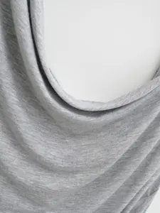 Detailed macro shot of grey heather knit fabric showing soft draped texture and folds