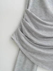 Macro view of the soft gray ruched fabric detail on a summer minimalist knit vest