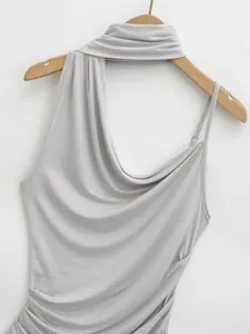 Close-up detail of a light grey asymmetric halter neck top with elegant draped design