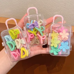 Set of colorful mini flower hair claw clips for kids in cute mini suitcase containers