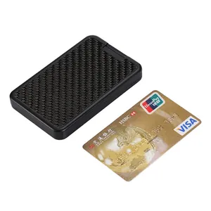 Close-up detail of a carbon fiber RFID blocking card holder next to a credit card