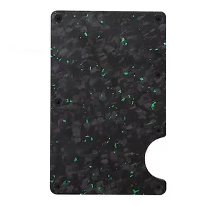 Close-up detail of forged carbon fiber card holder plate with green decorative flakes