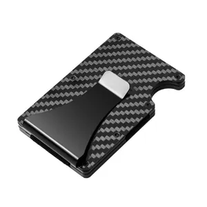 Detailed view of slim carbon fiber card holder with black metal money clip and RFID blocking