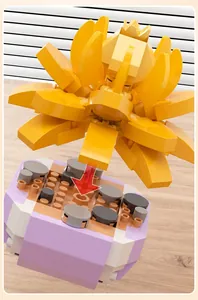 Detailed view of yellow succulent building block being assembled on a purple base