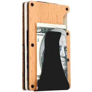 Detail view of RFID blocking wood wallet with black metal money clip holding cash.
