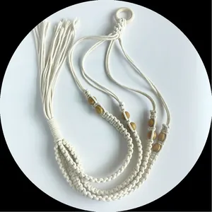 Detailed view of handmade macrame plant hanger with cotton rope and wooden beads