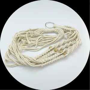 Detail view of a bohemian handmade macrame plant hanger with cotton rope and wooden beads