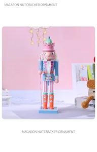 Detailed view of a macaron-colored wooden nutcracker ornament with pink crown