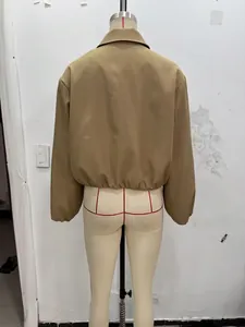 Back view of stylish khaki cropped puff jacket on mannequin showing elastic hem detail