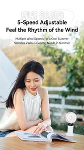 Detailed shot of portable white USB fan with digital display on outdoor table