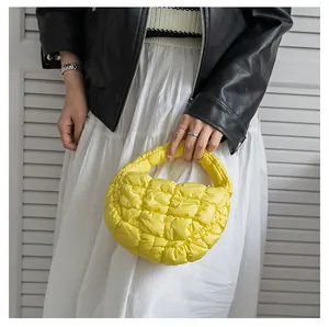 Vista dettagliata di una mini borsa trapuntata giallo brillante con imbottitura in piuma