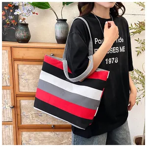 Striped canvas tote bag for women, large capacity shoulder shopping bag model shot.