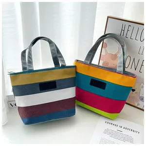 A pair of colorful striped canvas tote bags displayed in a bright lifestyle setting