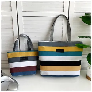 Detailed view of two striped canvas tote bags in different sizes for daily shopping