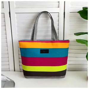 Detailed view of a vibrant colorful horizontal striped canvas tote bag with KMY logo