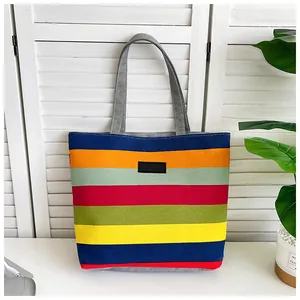 Detailed full view of a colorful horizontal striped canvas tote bag with grey straps.
