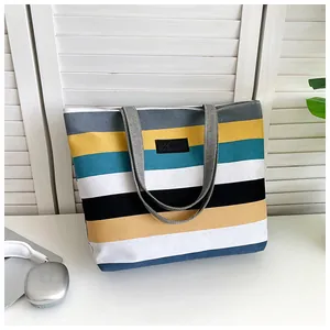 Detailed view of large capacity canvas tote bag with colorful striped pattern