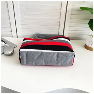 Detailed bottom view of a large striped canvas tote bag with reinforced stitching