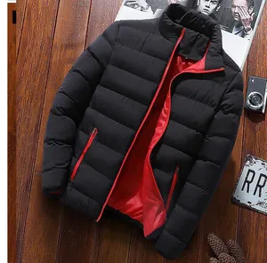 Detailed macro view of a men's black puffer jacket with vibrant red inner lining