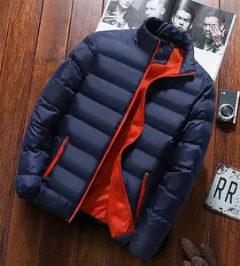 Detail view of navy blue puffer jacket featuring horizontal quilting and bright orange lining