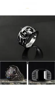 Detailed view of vintage punk style rings including a skull motif and zircon stones