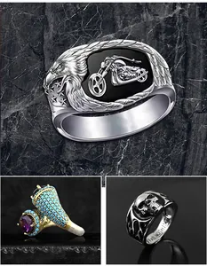 Detail view of various vintage punk rings featuring eagle motorcycle and skull designs.