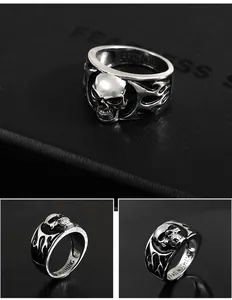 Detailed close-up views of a vintage punk skull ring with silver flame patterns