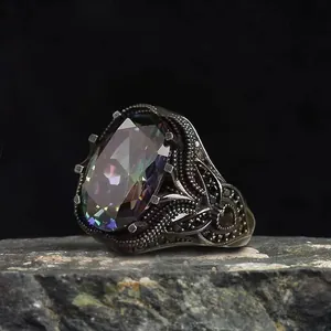 Vintage punk style ring with large oval iridescent zircon and ornate engraved pattern