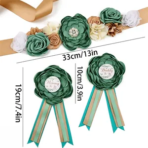 Detailed view of the green floral maternity sash and parent-to-be badges with dimensions