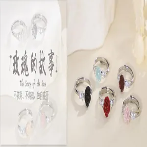 Detailed view of elegant silver-toned rose rings with colorful enamel finishes