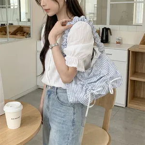 Blue and white striped ruffled shoulder bag featuring dainty white ribbon bow details.