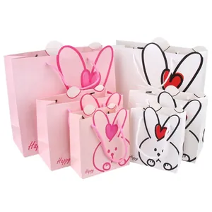 Cute rabbit paper gift bags in pink and white for birthday party favors and candy