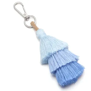 Macro view of blue gradient three-layer cotton tassel with silver metal clasp