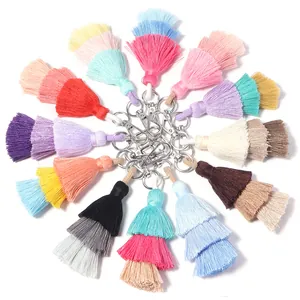 Detailed view of colorful three-layer cotton tassels with metal lobster clasps for bags