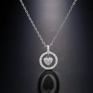 Macro view of silver heart necklace with pavé-set crystals in a circular pendant