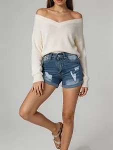 Détail de short en jean bleu à taille haute pour femme avec déchirures et ourlet revers