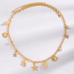Detailed view of Bohemian gold body chain decorated with starfish shells and pearls