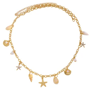 Detailed view of bohemian gold body chain with starfish and shell pearl charms
