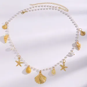 Close-up of Bohemian pearl waist chain with golden starfish and sea shell charms