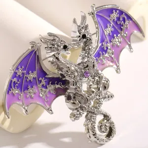 Close-up of fantasy double-headed dragon brooch with purple snowflake wings detail