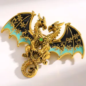 Close-up of fantasy dual-headed dragon brooch with teal enamel and snowflake pattern