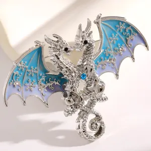 Exquisite detail of fantasy double-headed dragon brooch with blue snowflake enamel wings