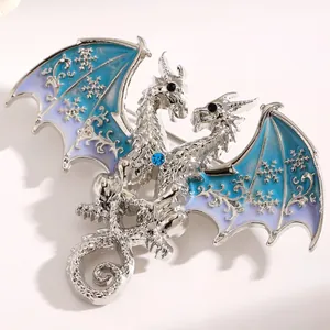 Detailed macro view of a silver fantasy dragon brooch with blue snowflake wings