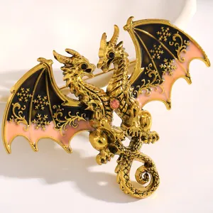 Close-up of golden double-headed dragon brooch with black enamel snowflake wings