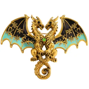 Close-up detail of a fantasy double-headed dragon brooch with blue enamel wings and snowflakes
