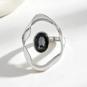 Detailed view of an irregular silver-tone ring featuring a faceted black oval stone.