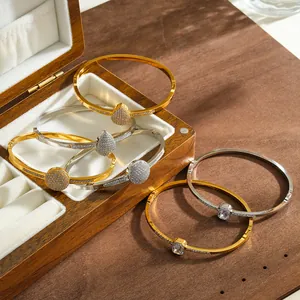 Detail shot of sparkling rhinestone-encrusted stainless steel bangles in a jewelry box