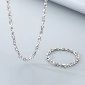 Detail view of twisted rope chain necklace and bracelet set in polished silver